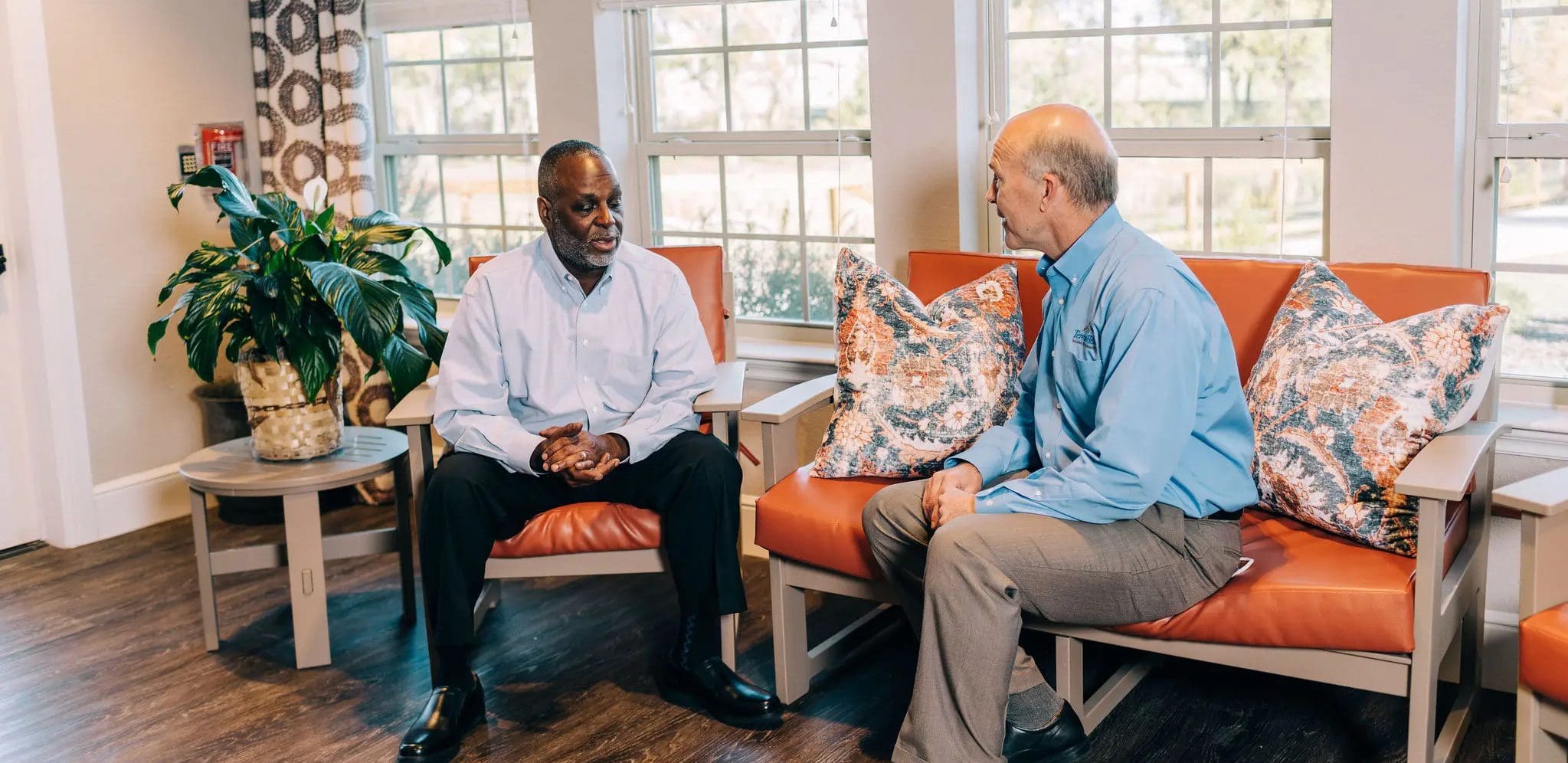 two men discussing senior care facilities philosophy