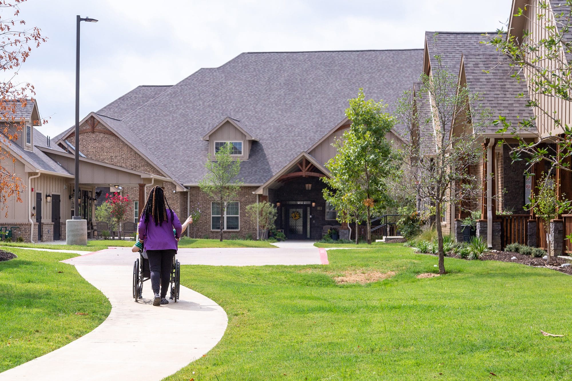 Elderly people taking a stroll on a beautiful day outside Teresa's House