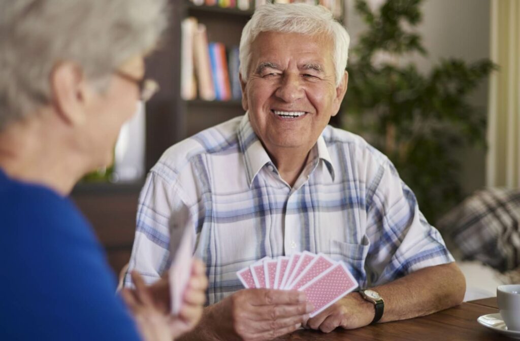 group of seniors playing card games to help support their cognitive health