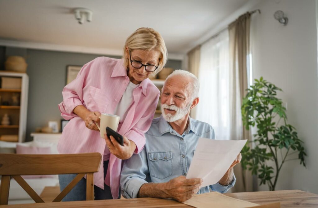 A mature couple researching to learn if they qualify for assisted living.
