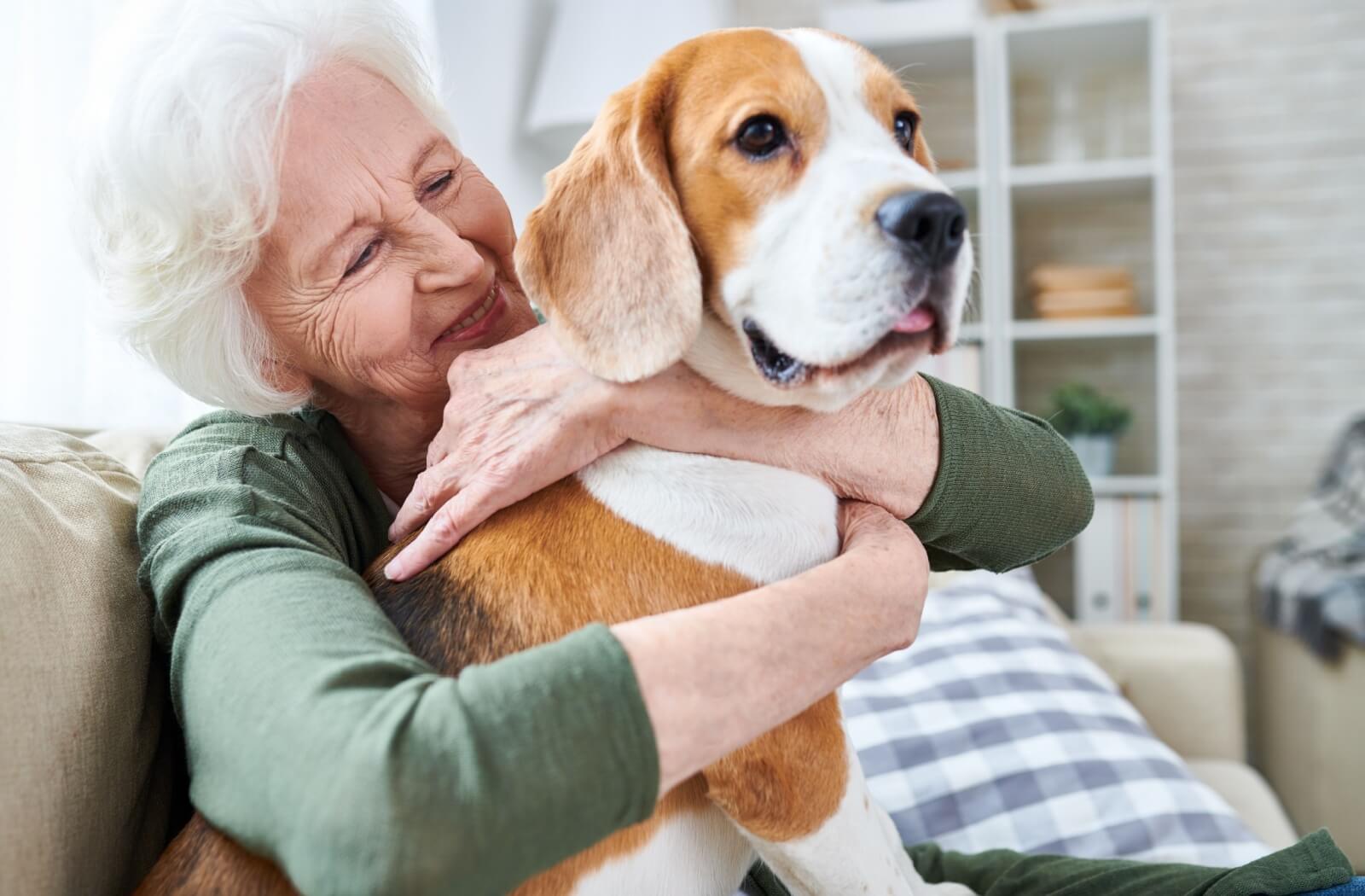 Senior resident sitting with their dog in an assisted living community.